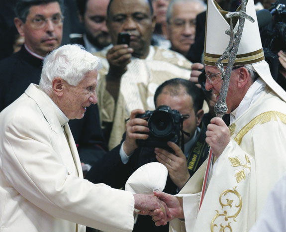 Retired Pope Benedict XVI greets Pope Francis at the conclusion of a consistory at which Pope Francis created 19 new cardinals in St. Peter’s Basilica at the Vatican Feb. 22. Pope Benedict’s presence at the ceremony marked the first time he had joined Pope Francis for a public liturgy.