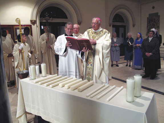Bishop Nicholas DiMarzio blesses candles used during the liturgy for the World Day for Consecrated Life at St. James Cathedral-Basilica.