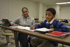 St. Francis College junior Michelle Rosenberg tutors Harlem RENS basketball player Jalen Smith. The tutoring program helps the young student-athletes realize that schoolwork comes before athletics. (Photo courtesy St. Francis College)
