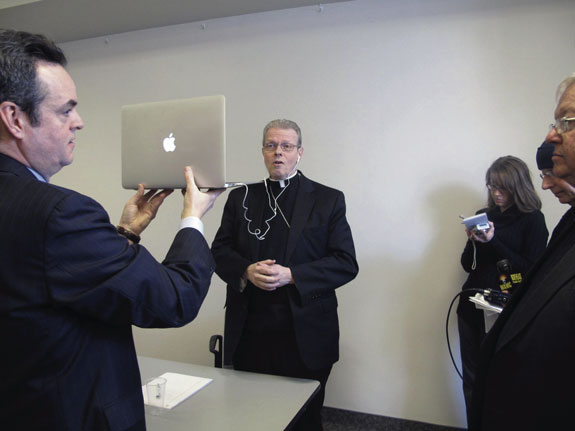 Bishop-designate Scharfenberger does a media interview via Skype during his introductory press conference in Albany.