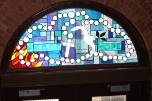 This stained-glass window at Immaculate Conception School is a 9/11 memorial and was created under the direction of the school’s Aquinas Program. Bishop Nicholas DiMarzio blessed it during his visit to the school. (Photo by Jim Mancari)