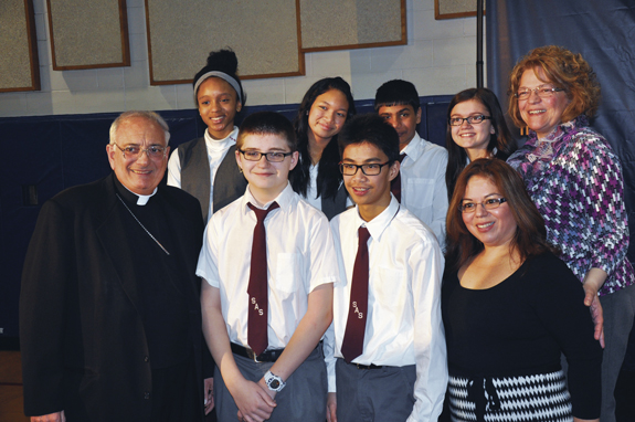 Bishop Nicholas DiMarzio and Katia Saca, lower right, pose with the delegation from St. Adalbert’s School, Elmhurst, at the press conference announcing support for an Education Incentive Tax Credit.