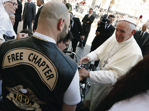 Pope Francis greets a Harley-Davidson biker as he meets with pilgrims who have disabilities following Mass in St. Peter’s Square at the Vatican in June. Though he prefers walking and cheaper car models, Harley-Davidson gave him a brand new Dyna Super Glide in June that the pope autographed and put up for auction, raising a hefty $326,000 for a Rome soup kitchen and homeless shelter. 