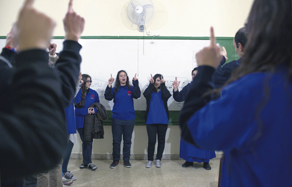 Students pray in the classroom of St. George School in the Zalka section of Beirut after distributing aid during the first Youth of Life visit March 14.