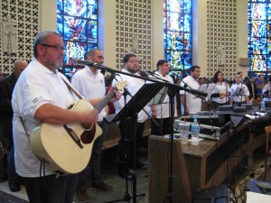 The Jornada music group leads the youth in songs of praise during Mass; the group helped the youth meditate later in the day during Holy Hour