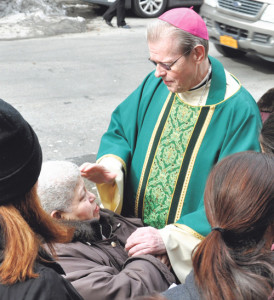 Bishop-elect Scharfenberger’s compassion is evident when he interacts with people as he did here outside Our Lady of the Angelus Church.