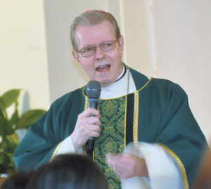 Bishop-elect Scharfenberger exhibits his relaxed style of preaching during a pastoral visit to Our Lady of the Angelus, Rego Park, last month.