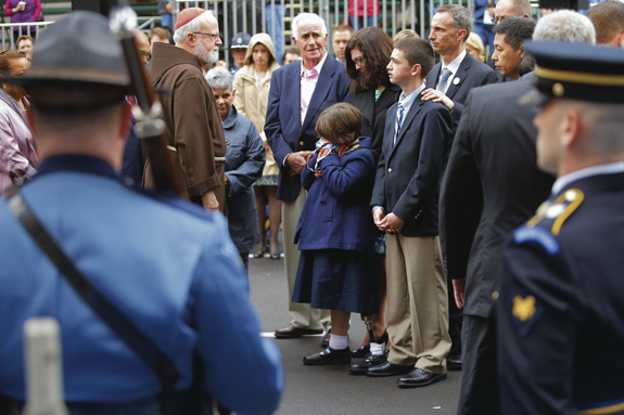  Boston Cardinal Sean P. O’Malley joins the family of Boston Marathon bombing victim Martin Richard at the finish line for a wreath-laying ceremony in Boston April 15. The ceremony was one of many events marking the first anniversary of the bombing.