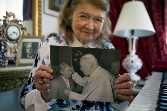 Poet Lena Allen-Shore holds an undated photo of herself pictured with Blessed John Paul II, whom she considered a dear friend. Allen-Shore is Jewish and was born in the late pope’s native Poland, where her family managed to avoid being taken to a Nazi concentration camp during the Holocaust. 