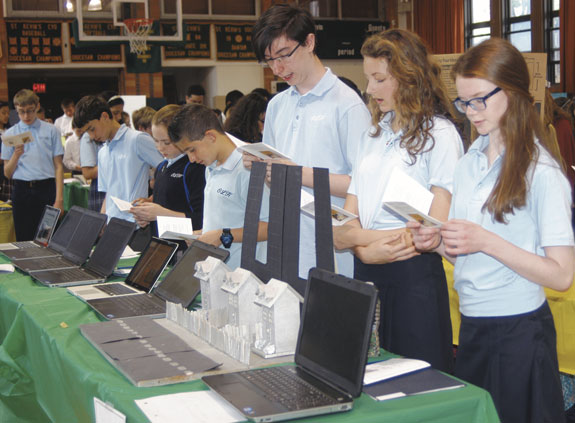 Students opened the Aquinas Society Expo at St. Kevin School, Flushing, above, with a prayer written by St. Thomas Aquinas. Twenty-three Catholic schools and academies participated in the Queens event.