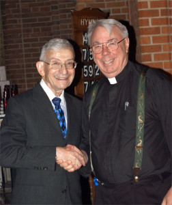Rabbi Alvin Kass shakes hands with Father Michael Perry, pastor of Our Lady of Refuge, Flatbush, after an Interfaith Thanksgiving Prayer Service at Our Lady of Refuge in this 2011 file photo.