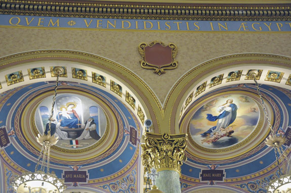 St. Joseph’s Co-Cathedral features new as well as restored artwork. Above the choir loft can be found a contemporary mural of modern-day saints and those on their way to sainthood. The main altar features new lighting. Below, the coats of arms of Brooklyn’s first Bishop, John Loughlin, is one of eight episcopal insignias to adorn the church.