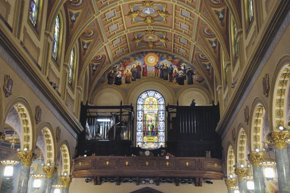 St. Joseph’s Co-Cathedral features new as well as restored artwork. Above the choir loft can be found a contemporary mural of modern-day saints and those on their way to sainthood. The main altar features new lighting. Below, the coats of arms of Brooklyn’s first Bishop, John Loughlin, is one of eight episcopal insignias to adorn the church.
