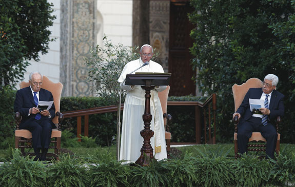 Pope Francis speaks during an invocation for peace with Israeli President Shimon Peres, left, and Palestinian President Mahmoud Abbas, right, in the Vatican Gardens June 8.