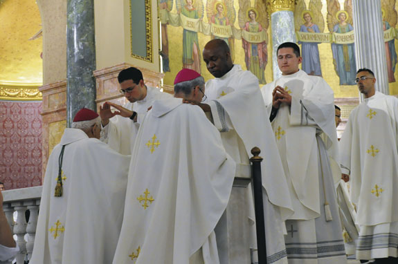 Fathers Jeremy Canna and Robert Pierre-Louis confer first blessings on Auxiliary Bishops Guy Sansaricq and Paul Sanchez.