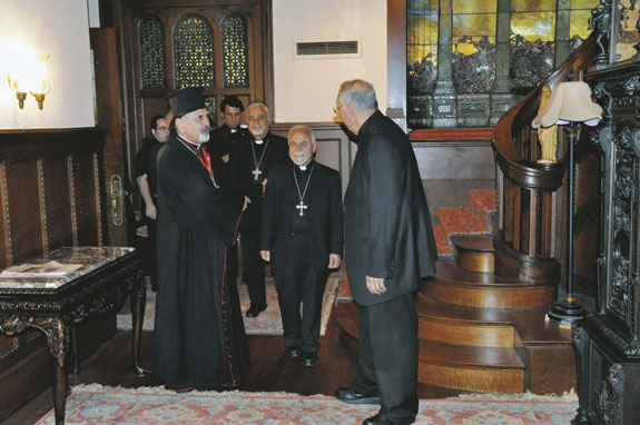 Bishop Nicholas DiMarzio greets, from left, Patriarch Ignatius Joseph III Younan; Archbishop Yousif Abba of Baghdad; and Bishop Georges Qasmousa, patriarchal vicar for the Syriac Catholic Church, in Brooklyn on July 23.