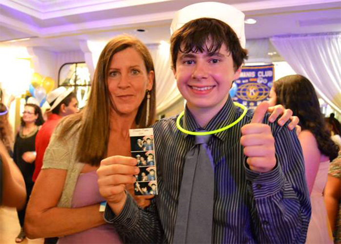 Jonathan, who attends The HeartShare School, gave the family-friendly “Dream Prom” a thumbs-up as he stands on the dance floor with his mother, Marie. 