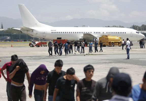 Migrants from Guatemala deported from the U.S. arrive at La Aurora International Airport in Guatemala City July 10. A growing wave of families and unaccompanied minors fleeing Guatemala, El Salvador and Honduras are streaming by the thousands into the U.S.