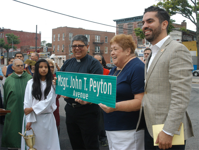 On hand for the street renaming were, from right, City Councilman Rafael L. Espinal, who spearheaded the renaming effort for his late pastor; Maureen Peyton, the late priest’s sister; and Father Luis Laverde, pastor of St. Rita Church. 