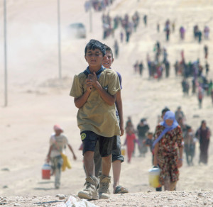 Children flee violence from forces loyal to the Islamic State in Sinjar, Iraq. Islamic State militants have killed at least 500 Yezidi ethnic minorities, an Iraqi human rights minister said. (Photo © Catholic News Service/Reuters)