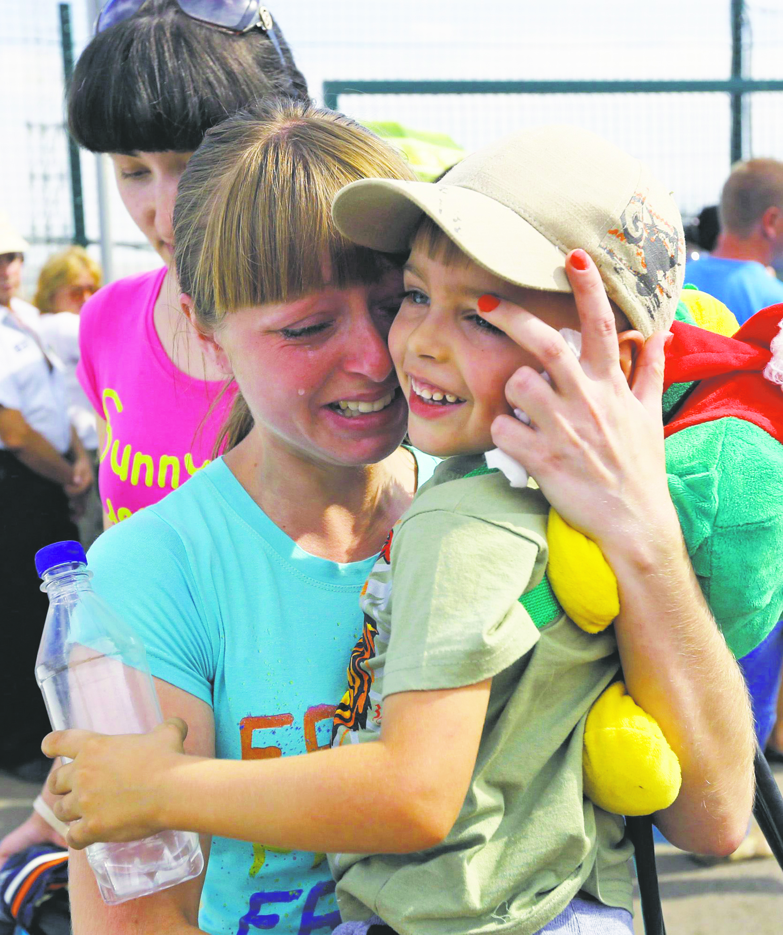 A Ukrainian woman cries tears of joy after being reunited with her son at the Russia-Ukraine border Aug. 22. As Ukrainians marked their Independence Day Aug. 24 amid ongoing tensions, Pope Francis prayed for “peace and tranquility” there.