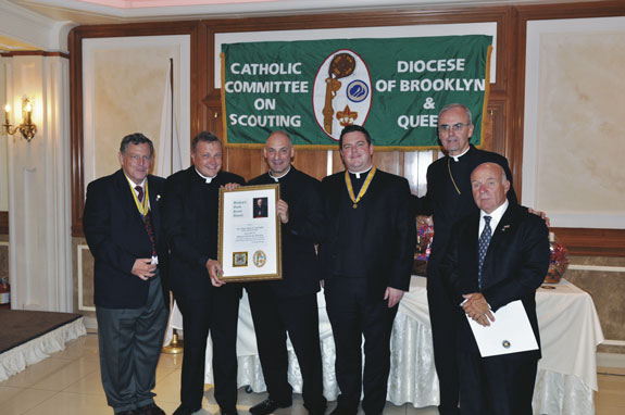 Msgr. Kieran Harrington, vicar for communications, receives the Good Scout Award from Father Thomas Vassalotti.