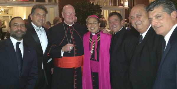 Cardinal Timothy Dolan, Archbishop Bernardito C. Auza, permanent observer of the Holy See to the UN, and Msgr. Jamie J. Gigantiello,  diocesan vicar for development join with friends of Msgr. Gigantiello as they congratulate him at the Waldorf-Astoria upon being installed as a chaplain of the Sovereign Order of Malta.    
