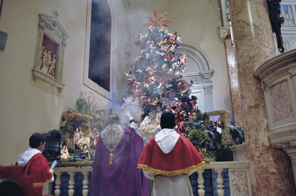 Above, Father Saffron blesses the Angel Tree.