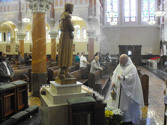Father Philip Pizzo blesses statue of St. Benedict Joseph Labre