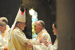 Archbishop John C. Nienstedt of St. Paul and Minneapolis offers the greeting of peace to Deacon Vaughn Treco May 2 at the Basilica of St. Mary in Minneapolis. A day later Deacon Treco, a former Anglican priest, became Father Treco when ordained a Catholic priest by Auxiliary Bishop Andrew H. Cozzens at Holy Family Church in suburban St. Louis Park. (CNS photo/Dianne Towalski, The Catholic Spirit) 