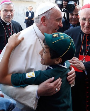 Pope Francis greeted a scout while visiting Queen of Peace Parish in Ostia on the outskirts of Rome. (Photo by Catholic News Service/Paul Haring)