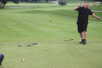 Chris Murphy sinks his putt at the annual CYO Golf Outing that benefitted Catholic youth programs in Brooklyn and Queens.