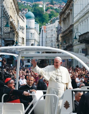 Pope Francis arrives for a meeting with priests, men and women religious and seminarians in Sacred Heart Cathedral in Sarajevo, Bosnia-Herzegovina, June 6. Also pictured in the popemobile is Bosnian Cardinal Vinko Puljic of Sarajevo. The pope was making a one-day visit to Bosnia-Herzegovina to encourage a minority Catholic community in the faith, and to foster dialogue and peace in a nation still largely divided along ethnic lines