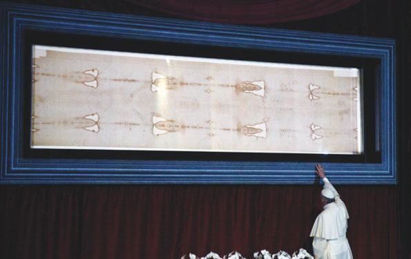 Pope Francis touches the case holding the Shroud of Turin after praying before the cloth in the Cathedral of St. John the Baptist in Turin, Italy, June 21. (Photo Catholic News Service/Paul Haring)