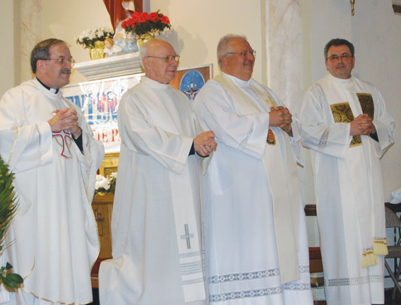 At the closing Mass of the centennial year for Holy Cross Church, Maspeth, are from left, from left, Msgr. John J. Strynkowski, former pastor; Msgr. Thomas Machalski, who was raised in the parish; and Father Witold Mroziewski, pastor. 