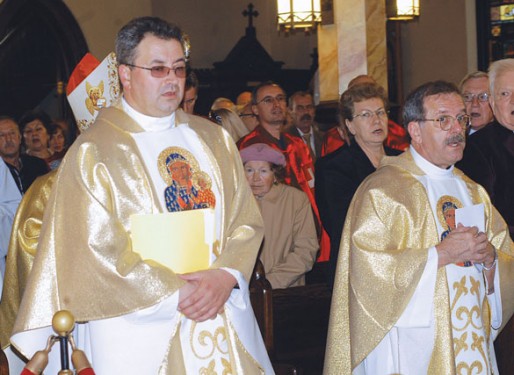 Bishop Mroziewski, left, is accompanied by Msgr. Peter Zendzian as they process up the main aisle of Our Lady of Czestochowa Church, Sunset Park, for a Polish Heritage celebration.