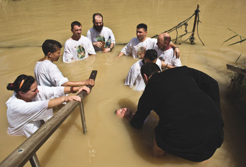  Christian pilgrims dip in the water at the baptismal site known as Qasr el-Yahud on the banks of the Jordan River near the West Bank city of Jericho. (Photo by Catholic News Service/ Nir Elias, Reuters) 