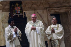 Bishop DiMarzio is flanked by Dominican-born Deacon Jose Henriquez, right, and Haitian-born Deacon Yvon Aurelien at a special Mass for Haitians being threatened with deportation from the Dominican Republic. (Photo by Ed Wilkinson)