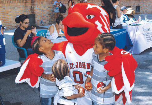 The street festival included music, dancing and appearances by children’s favorite characters such as Minnie Mouse and Johnny Thunderbird, mascot of the St. John’s University Red Storm.