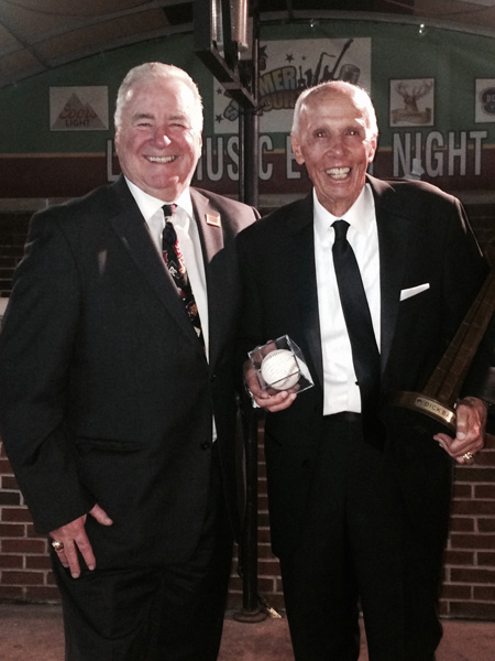 Dick Bavetta, right, Hall of Fame NBA referee, is congratulated by Ray Nash, president of the Brooklyn-Queens CHSAA, upon being inducted into the Basketball Hall of Fame in Springfield, Mass. Bavetta is holding a baseball signed by Cal Ripken in recognition of being dubbed the Iron Man of referees. (Photo courtesy Ray Nash)