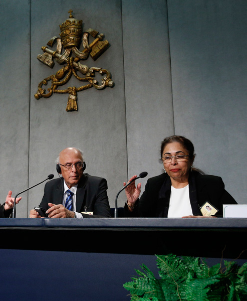 Ishwar and Penny Bajaj  speak during a press briefing after the morning session of the Syond of Bishops on the family at the Vatican Oct. 12. The couple from Mumbai, India, are observers at the synod. (Photo by Paul Haring)