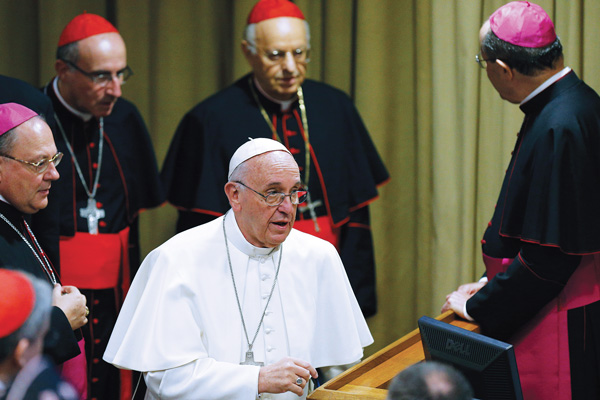 Pope Francis arrives to lead a session of the Synod of Bishops on the family at the Vatican. (Photo © Paul Haring)