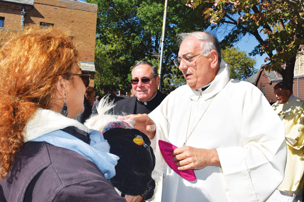 Bishop DiMarzio blesses animals as Msgr. Ralph Maresca, St. Francis’ pastor, looks on