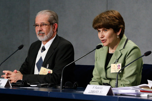 Ketty De Rezende, accompanied by her husband, Pedro, speaks at a media briefing following a session of the Synod of Bishops on the family at the Vatican Oct. 12. (Photo © Paul Haring)