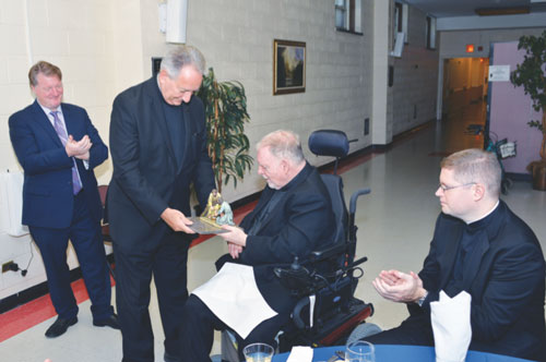 Father James Bradley received the Bishop Sullivan Award for service to Catholic Charities from Msgr. Alfred LoPinto. Looking on is Father Patrick Keating, chief of staff for Catholic Charities Brooklyn and Queens. 