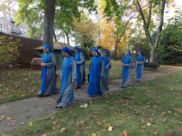 Sister Servants of the Lord and the Virgin of Matara pray as they walk in their convent in Borough Park. (Photos courtesy SSVM)