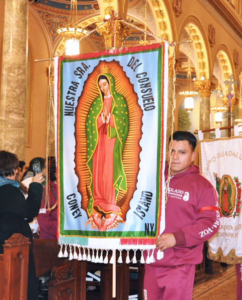 A banner with the image of Our Lady of Guadalupe is carried into St. Joseph’s Co-Cathedral during last year’s celebration of the feast. (Photo © Ed Wilkinson)