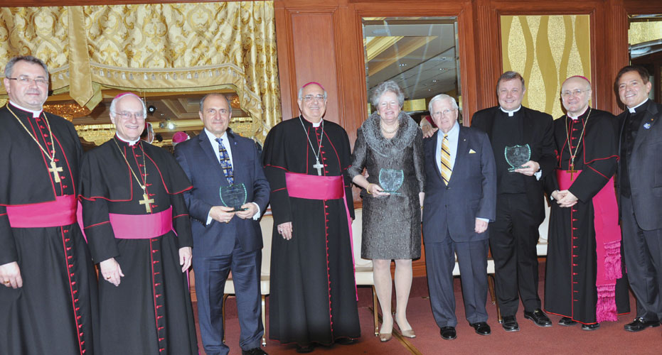 At the Bishop’s Christmas Luncheon, conducted by the Catholic Foundation, were, from left: Auxiliary Bishops Witold Mroziewski and Raymond Chappetto; Samuel E. Romanzo, recipient of the Emma A. Daniels Benefactor’s Award; Bishop Nicholas DiMarzio; Mary and Raymond Teatum, who received the Spirit of Hope Award; Msgr. Kieran Harrington, chairman of the board of DeSales Media Group, that was presented the St. John Paul II Distinguished Stewardship Award; Auxiliary Bishop James Massa; and Msgr. Jamie Gigantiello, diocesan vicar for development.