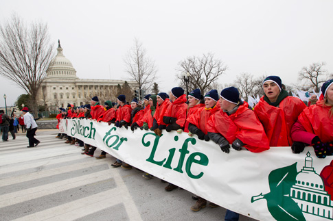 Young people walk with a banner past the U.S. Capitol in 2012 during the annual March for Life in Washington. (CNS photo/Bob Roller)