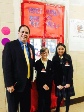 p District 22 Councilman Costa Constantinides assists student judges during Red Ribbon Week door decorating competition.